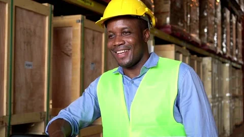 Slow motion man worker African American stand near shelf product in warehouse 動画素材 153384881