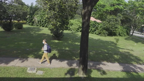 Slow motion man yellow pants walk Stock Footage 184817699