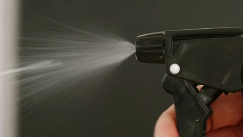 SLOW MOTION: Man's hand presses the sprayer - Close Up Stock Footage 105888152