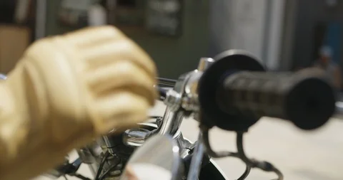 Slow motion of man's hand wearing yellow gloves and starting motorbike Stock Footage 124716622