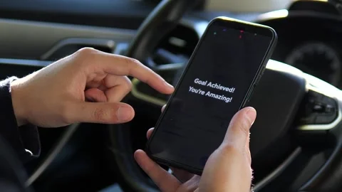 In slow motion, a mans hands hold a phone displaying a health and activity graph Stock Footage 318442982