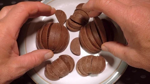 Slow motion: Man’s hands picking up chocolate pieces. Stock Footage 91089872