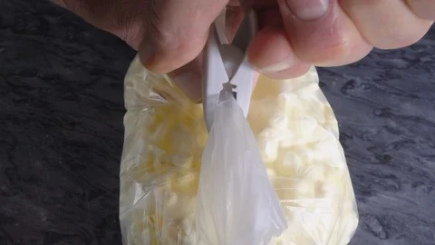 Slow motion - Man’s hands sealing a food bag with a clip / peg. Stock Footage 119656500