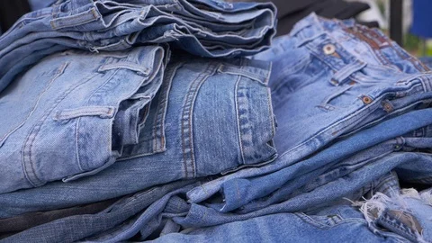 Slow motion, many blue jeans for sale in local street market in Thailand. Stock Footage