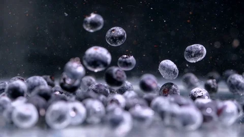 Slow motion, Many blueberries fall into the water slowly. Stock Footage 93328946