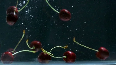 Slow motion, Many cherries fall into the water slowly. Stock Footage 93105015