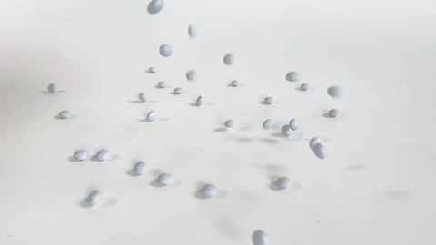 Slow motion of many gray pills falling. Stock Footage 250695000