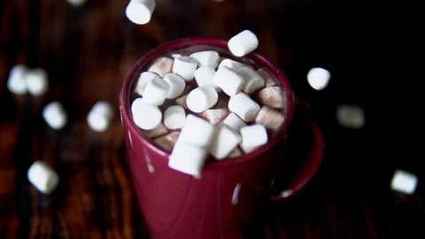 Slow motion of marshmallow falling into cup with hot chocolate cocoa drink Stock Footage 120415948
