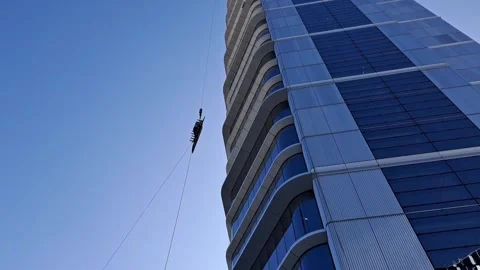 Slow motion of massive glass pane lifted high in golden light Stock Footage 337359368