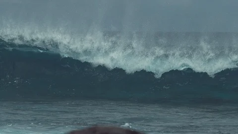 SLOW MOTION: Massive glassy ocean wave splashing towards remote tropical island. Stock Footage 91217988