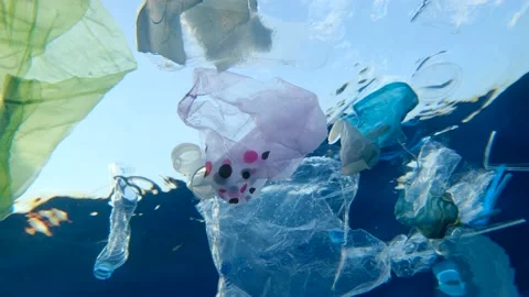 Slow motion, Massive plastic and other debris slowly drifts under surface of wat Video stock 143472175