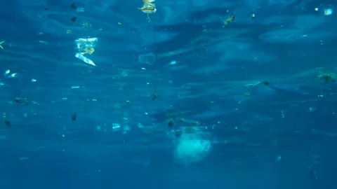 Slow motion, Massive plastic and other debris slowly drifts under surface of the Stock Footage 150449075