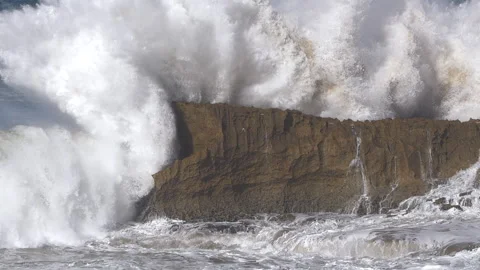 SLOW MOTION: Massive wave hits against cliff with an enormous explosion of water Stock Footage 314569668