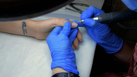 Slow motion. master of manicure removes cuticles on nails Stock Footage 114314509