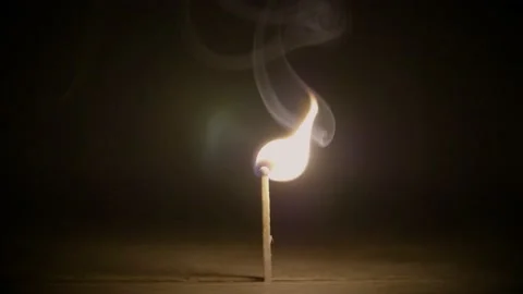 A slow motion Match burns bright in the darkness Stock Footage 137458708