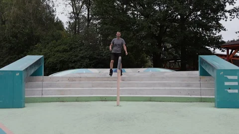Slow motion of a mature man riding backwards down concrete stairs on aggres.. Stock Footage 341431553