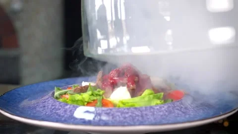 Slow motion. The meat salad under the glass cloche is filled with smoked smoke. Video stock 154888329