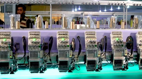 Slow motion medium shot of automatic embroidery machine with multiple heads  Stock Footage 199271977