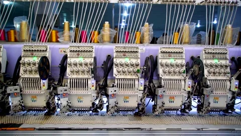 Slow motion medium shot of automatic embroidery machine with multiple heads  Stock Footage 199272039