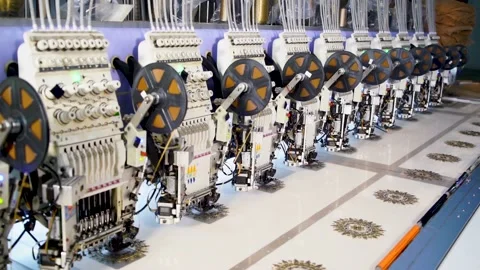 Slow motion medium shot of automatic embroidery machine with multiple heads  Stock Footage 199272041