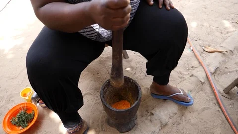 Slow motion medium shot of chili being crushed in mortar with pestle Stock Footage 116282064