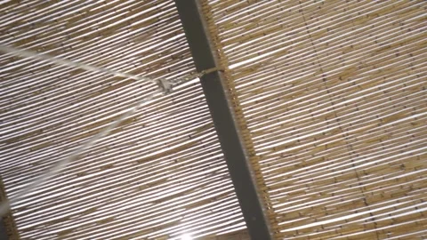 Slow motion medium shot of a reed roof from the POV of a swing Stock Footage 257949852