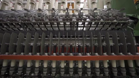 Slow motion medium shot of a spinning mill machine, camera tilting up Stock Footage 257762089