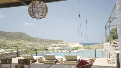 Slow motion medium shot of swing strings camera tilting to reveal pool Stock Footage 257950029