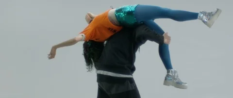 Slow motion medium shot of two people having fun and dancing on white background Stock Footage 126525724