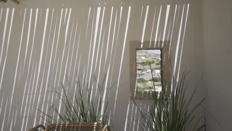 Slow motion medium shot of window looking at a village, focus on the village Stock Footage 257950884