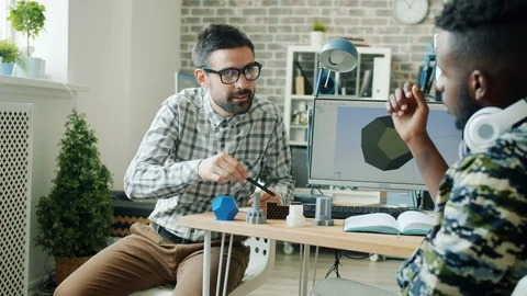 Slow motion of men discussing 3d printed elements for robot in modern office Stock Footage 119569635