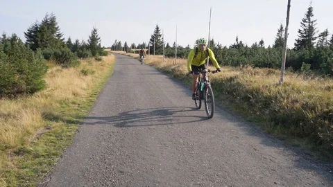 Slow motion men going on a bicycle adventure Stock Footage 127840911
