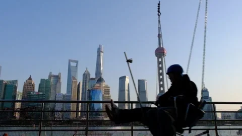 Slow Motion of men playing on the swing in China's Shanghai Stock Footage 301983399