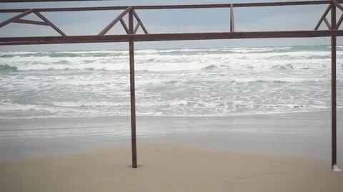 Slow motion metal construction on the beach and a storm Stock Footage 87503053