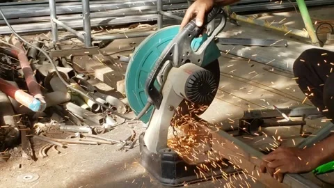 Slow motion Metal cutting machine with sparks in the backyard, Sparks of Electri Stock Footage 261293329