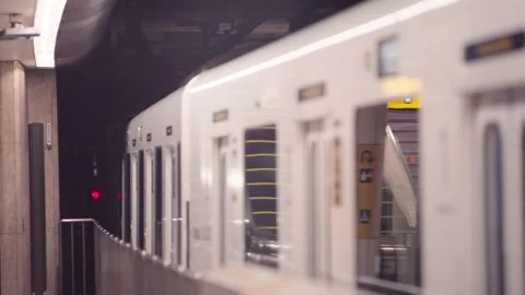 Slow motion of metro train departing platform with smooth motion and warm lights Stock Footage 322638580