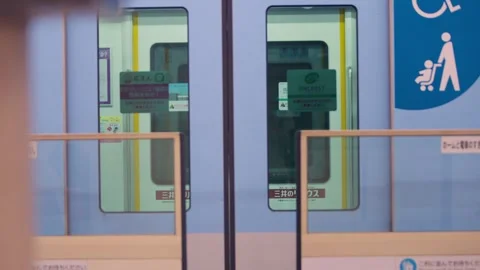 Slow motion of metro train doors closing as train departs clean platform Stock Footage 328414258