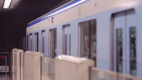 Slow motion of metro train passing platform with dynamic speed and bright lights Stock Footage 328414208