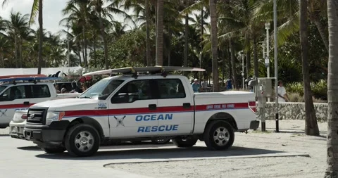 Slow motion Miami Beach ocean rescue trucks parallax tracking hero shot Stock Footage 147265664