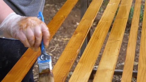 Slow motion mid shot of a brush slowly painting a wood piece. Stock Footage 113068885