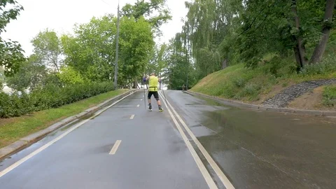 Slow motion middle-aged man, practicing roller skiing with sticks Stock-Footage 113060890