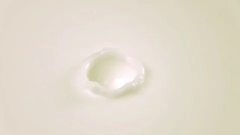 Slow-motion milk dropping and splashing. Stock Footage 79050823