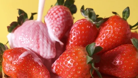 Slow motion milk falling on strawberries Stock Footage 124918685
