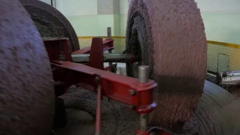 Slow motion of a millstone turns in a tuscan oil mill Video stock 82322903