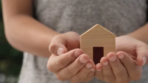 Slow motion at mini house model in boy hands lift to his face Stock Footage 124401393