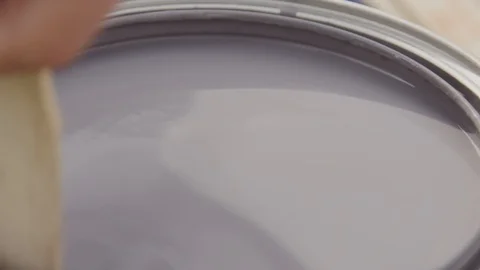 SLOW MOTION: Mixing a can of paint with a wooden stick Close Up Stock Footage