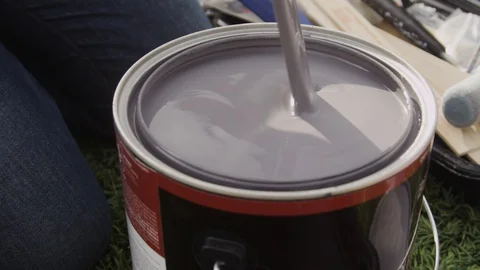 SLOW MOTION: Mixing a can of paint with a wooden stick Close Up Stock Footage 127597883