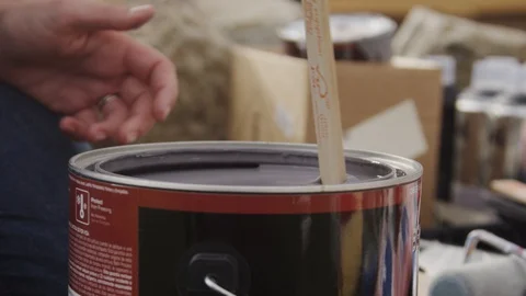 SLOW MOTION: Mixing a can of paint with a wooden stick Close Up Stock Footage 127597903