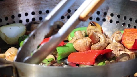 Slow motion mixing Mixed Vegetables with Peppers and Mushrooms in a Pan Video stock 307070367