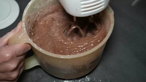 Slow Motion Mixing Smooth Chocolate Batter with Hand Mixer Video stock 320393496